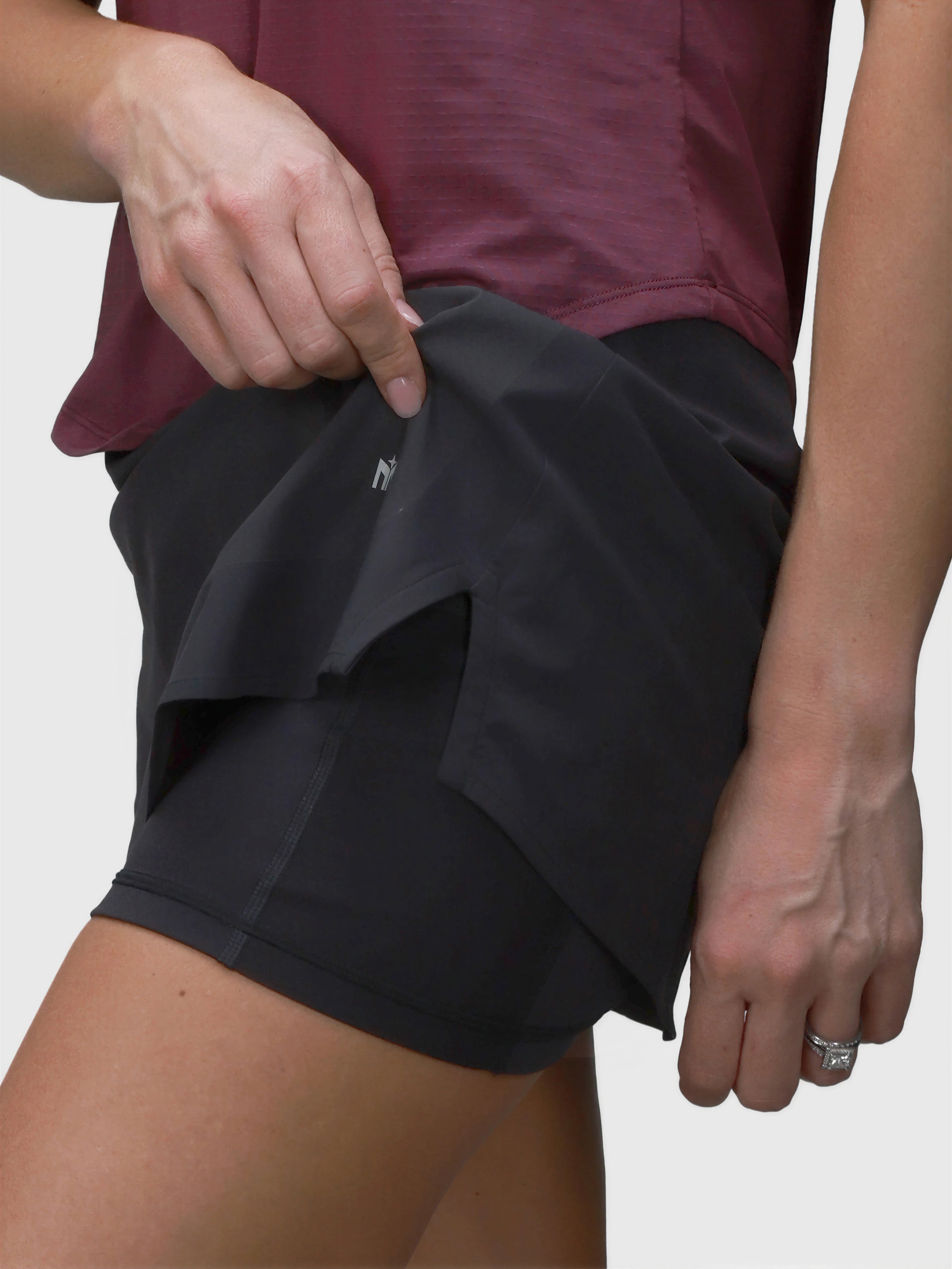 Close-up of black Motion Compression Skort by MUEV showing built-in shorts for pickleball and padel clothing