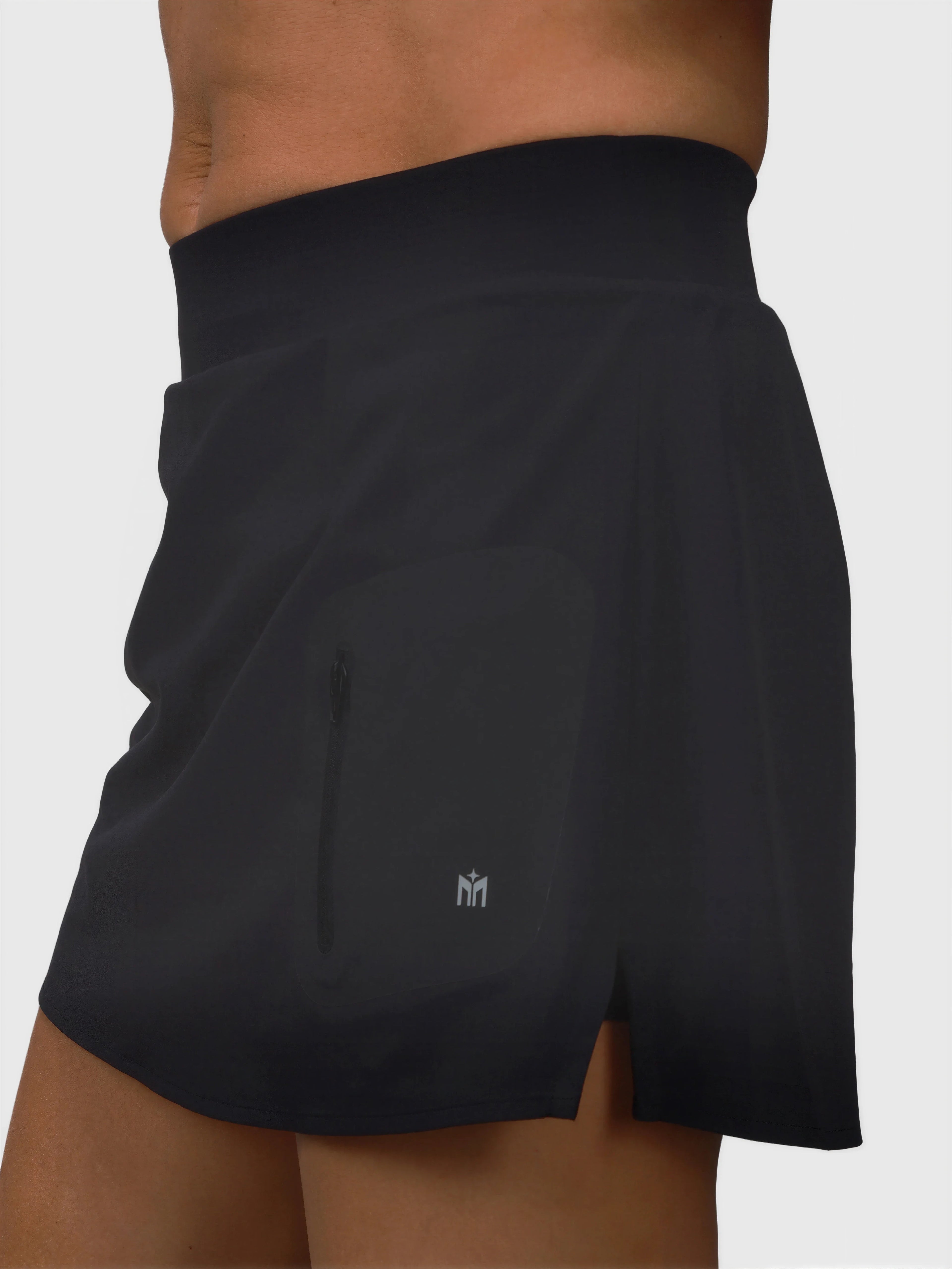 Side view of black Motion Compression Skort by MUEV with zip pocket for pickleball and padel apparel