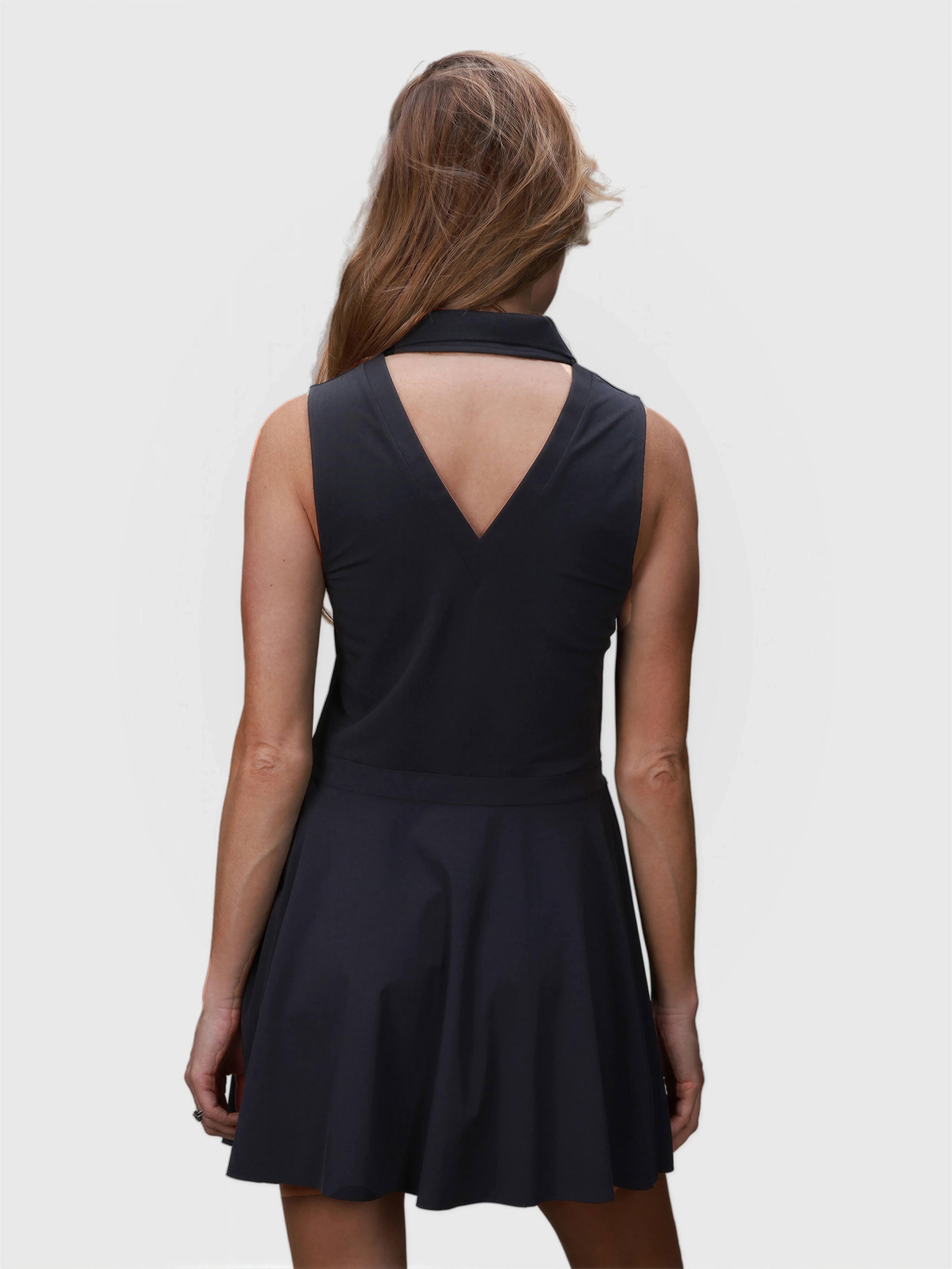 Back view of black Open Back Polo Dress by MUEV with V-shaped cutout for pickleball and padel clothing