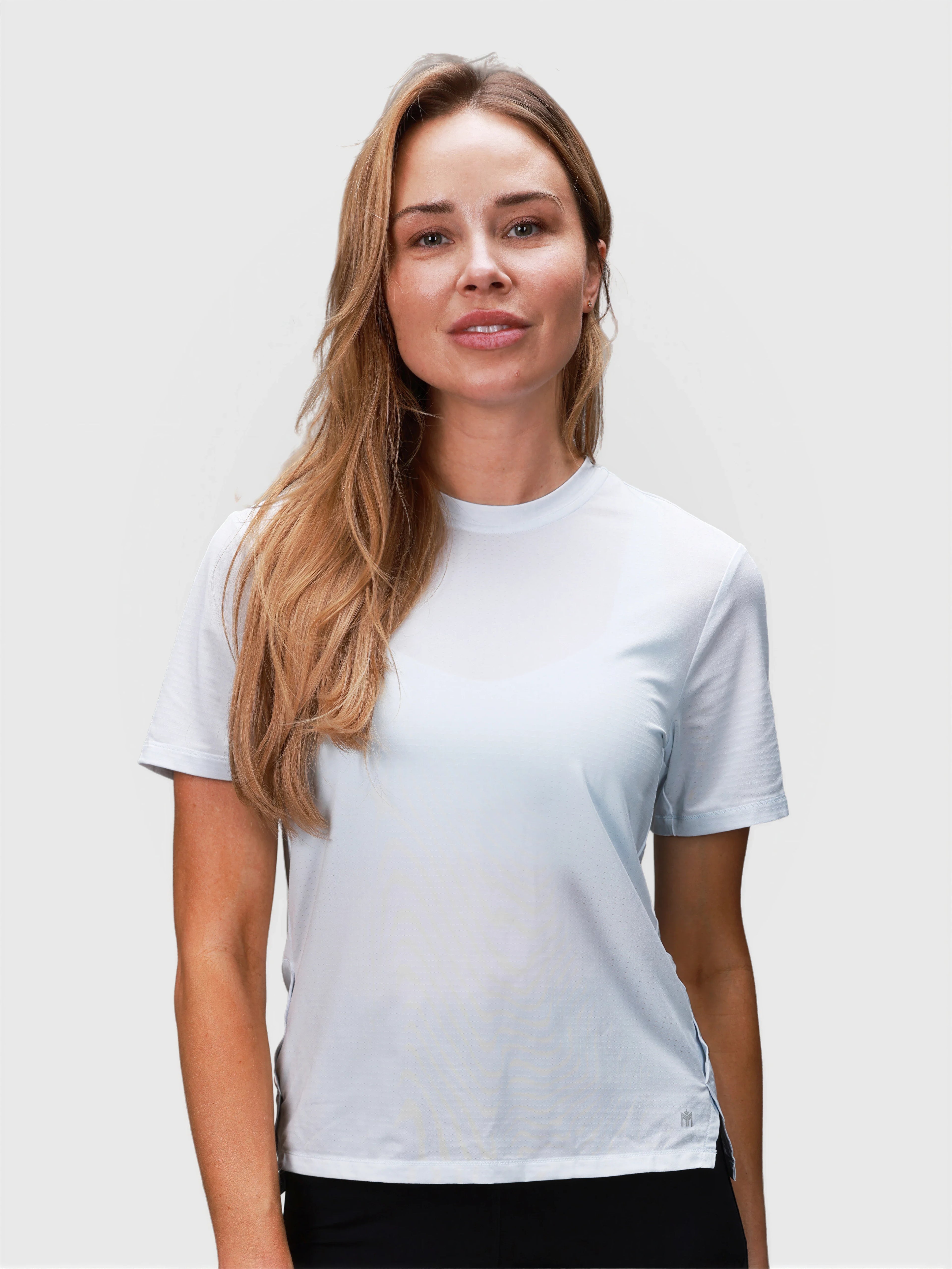 Front view of woman wearing ice blue PowerMove Performance Tee by MUEV for padel and pickleball apparel