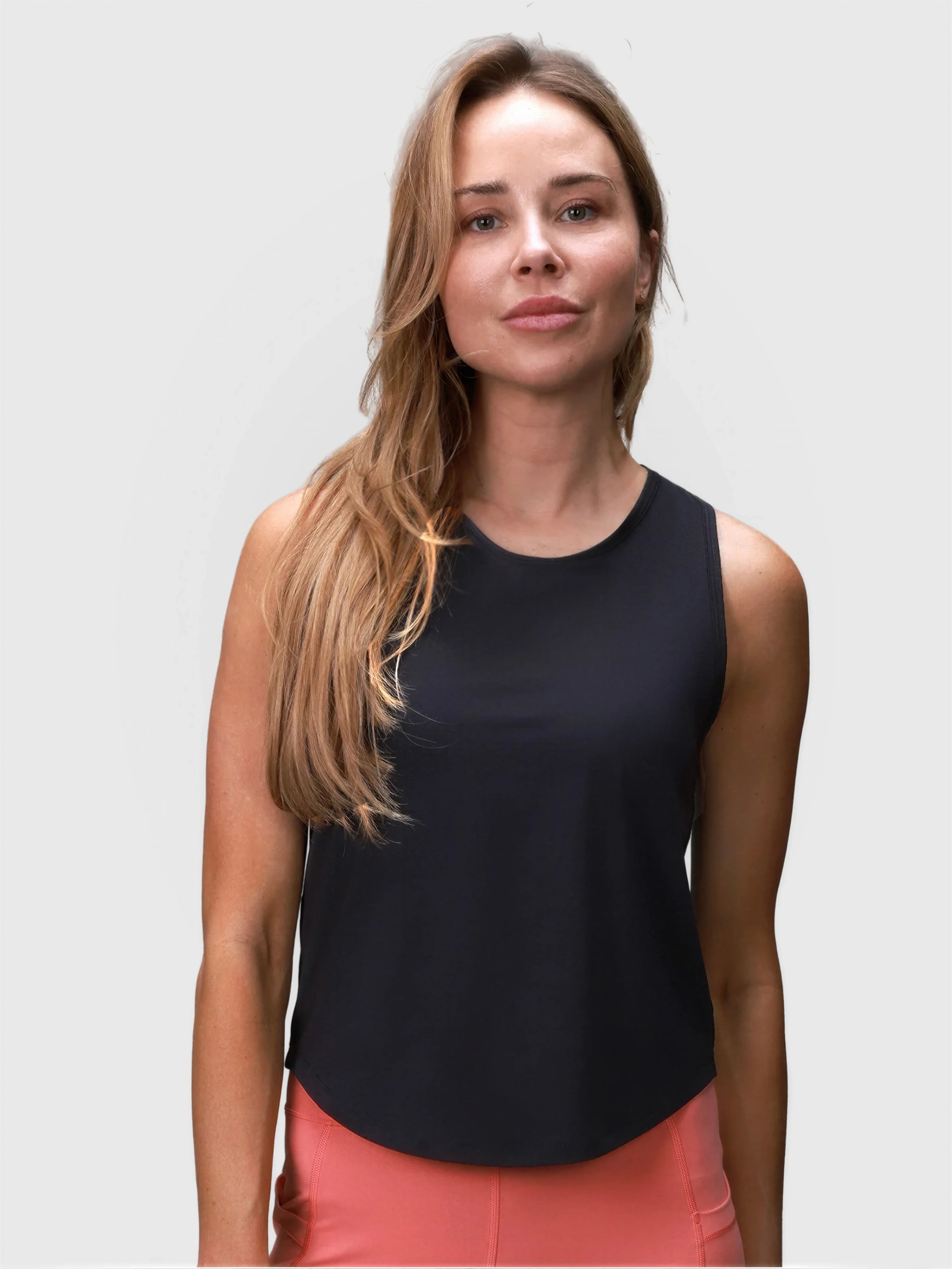 Woman wearing black Relaxed Tank by MUEV designed for padel and pickleball clothing with a loose fit